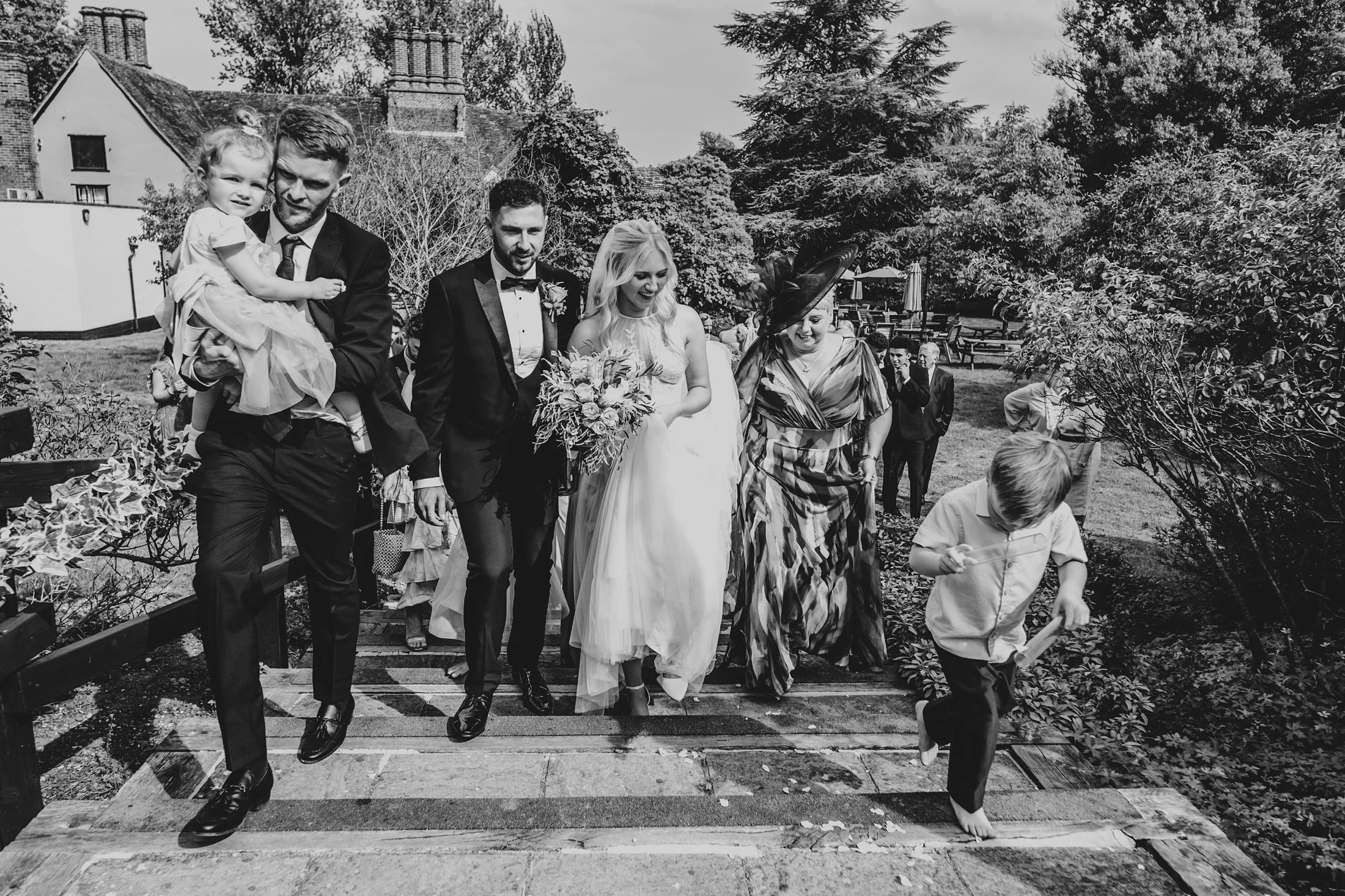 Delicate sage &amp; white paired with black tie for an early Autumn barn wedding at The White Hart, Great Yeldham. Essex documentary wedding photographer