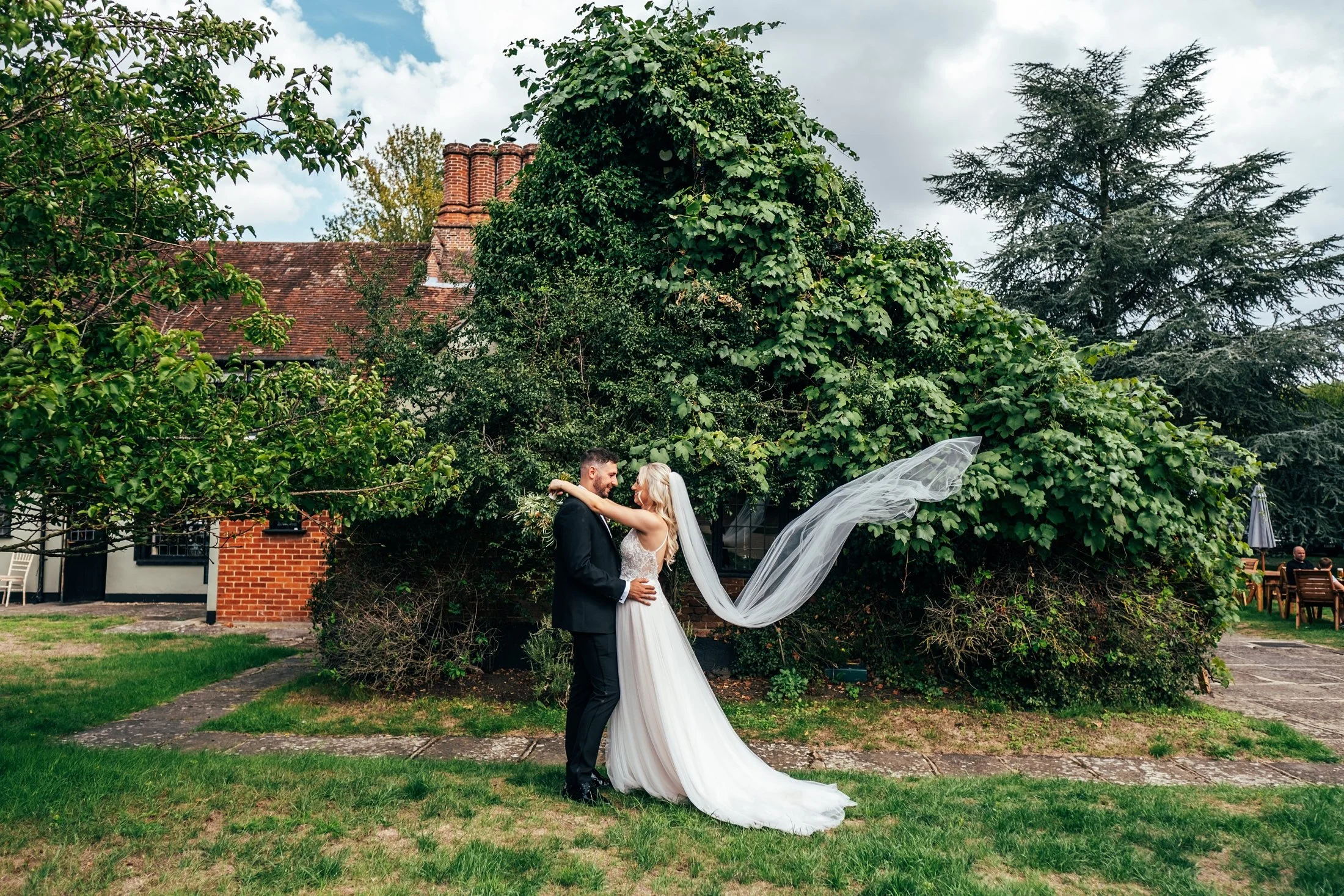 Delicate sage &amp; white paired with black tie for an early Autumn barn wedding at The White Hart, Great Yeldham. Essex documentary wedding photographer
