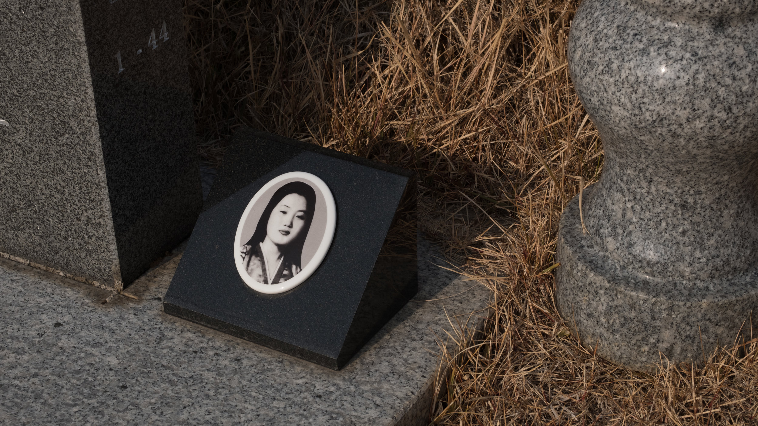 The grave of Sungja Yi, who was killed at 15 when government troops attacked pro-democracy protesters on 21 May 1980. She was among 54 people who died when army snipers positioned on rooftops fired at demonstrators. The May 18th National Cemetery was my first destination in Gwangju, and paying my respects to the victims of the Gwangju Uprising was the central purpose of my visit. Han Kang's Human Acts explores the wide ranging consequences of the violence perpetrated against students like Sungja Yi, including denying them decent burials and the bereaved the freedom to properly grieve their dead. Kang writes " After you died I couldn't hold a funeral, so my life became a funeral./After you were wrapped in a tarpaulin and carted away in a garbage truck. " Some of the demonstrators killed at Gwangju were indeed transported to burial in garbage trucks. I was almost alone among the 482 graves on the sunny December morning of my visit, giving me quiet time to reflect upon the remarkable courage of those buried here.