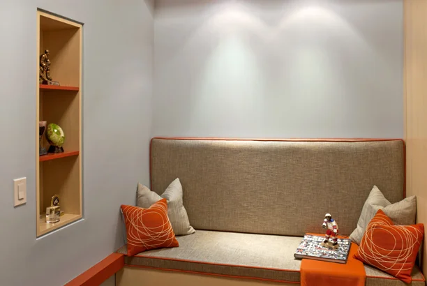 This project is a repurposing of a small TV room within the interior of a large apartment. It is intended to be a place to play, do homework, watch movies, and take an occasional snooze. The driving concept behind the design was based on an animated graphic of a line winding through the space. The plane of the line becomes the desk, the shelves, and organizes the elements within the woodwork. A double Murphy bed comes down over a built in sofa, and a custom bench serves as a seat for the desk and as storage.