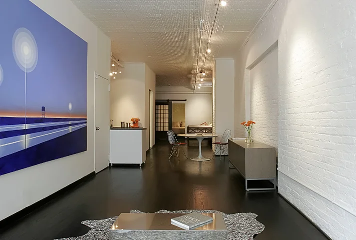 The Z Loft is a 1,100 sf space in Greenwich Village. The project brings calm back to a once maze like layout by creating a new bedroom and bath as the only two enclosed spaces in a large, open loft. The floors were updated, lighting was installed, walls were refinished, and a massive - though translucent - sliding door was added as a reference to the space's industrial past.