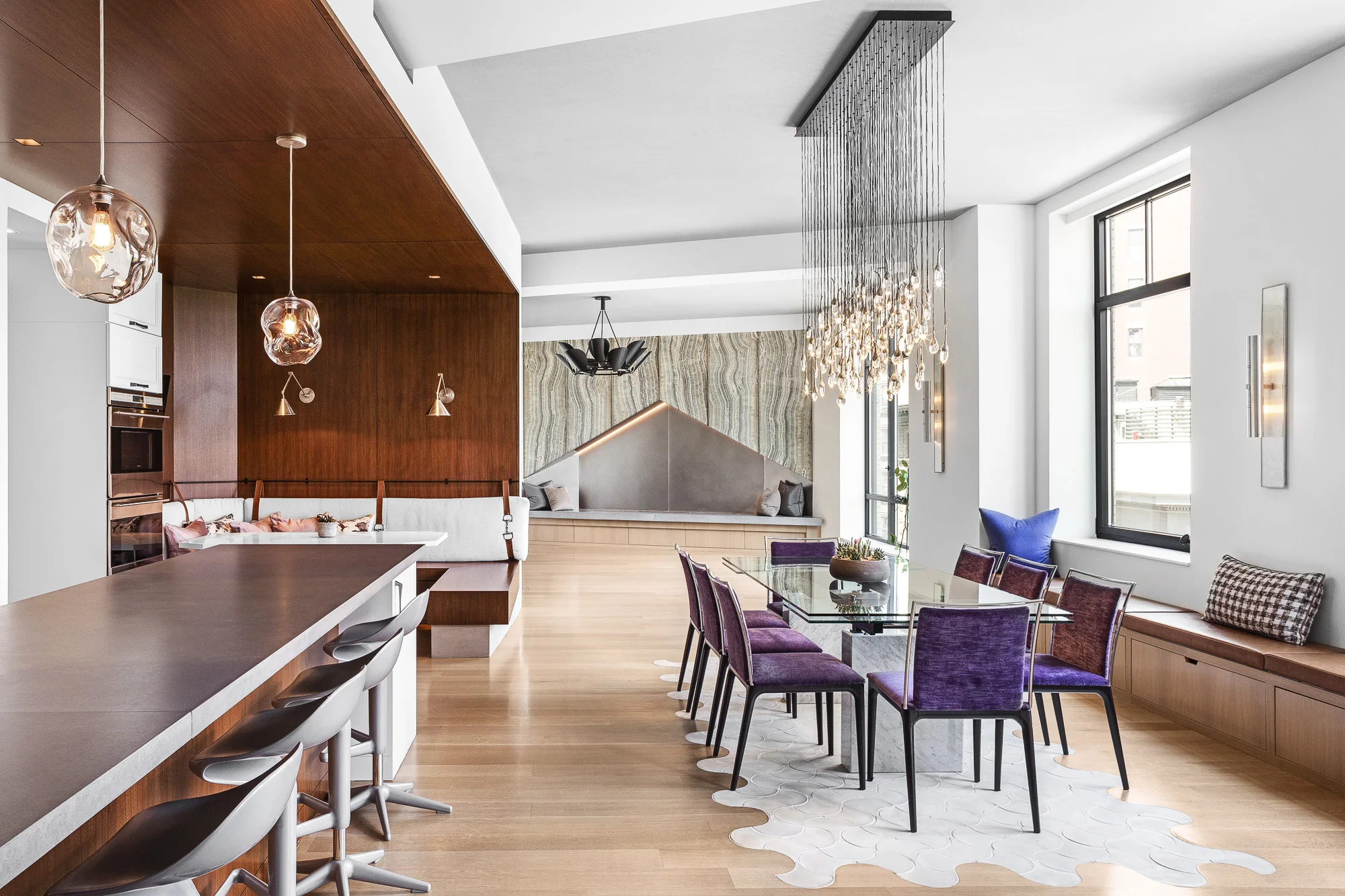 WG Flatiron was the third project Rodriguez Studio completed for the same great client. The architectural challenge was to create a new apartment combination in a building that had not been built yet. Two 3 bedroom units were combined to create a 4 bedroom, 4 and half bathroom apartment that sprawls over 5,000 sf. The existing layouts from the base building development were combined to also create a new office/den area, walk in closets, a media room, as well as a large pantry and a large living room dining room with built-in seating. Walnut, Bronze, glass, stucco, and stone are woven together throughout the project to create a strong aesthetic identity. The project is a sleek, modern design with vibrant materials and elegant details with commanding views of Manhattan. This project was completed with Kylie Sarley and Zendy Nevado of Kylie Sarley Interiors http://www.kyliesarley.com/