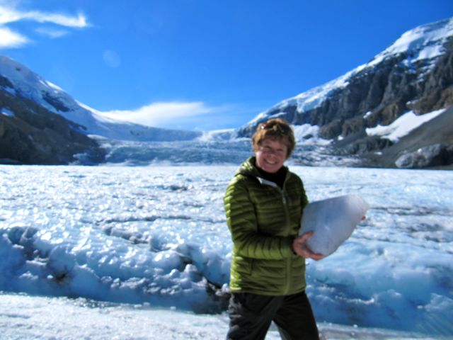 Paula at Columbia Icefield with a chunk of glacier in her hands BRR!