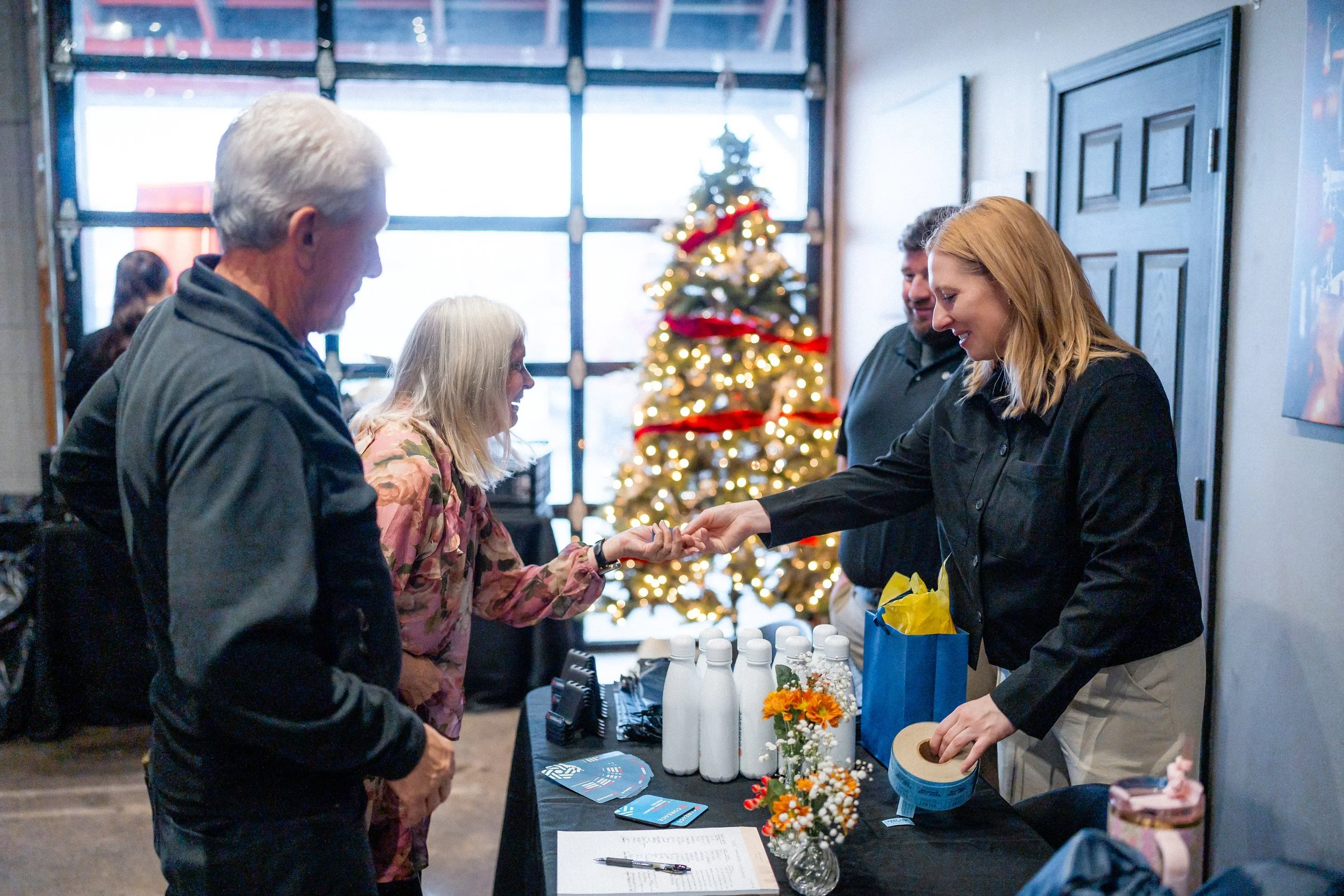 Corporate holiday event in Asheville with string lights, decorated tables, and Blue Ridge Mountain backdrop