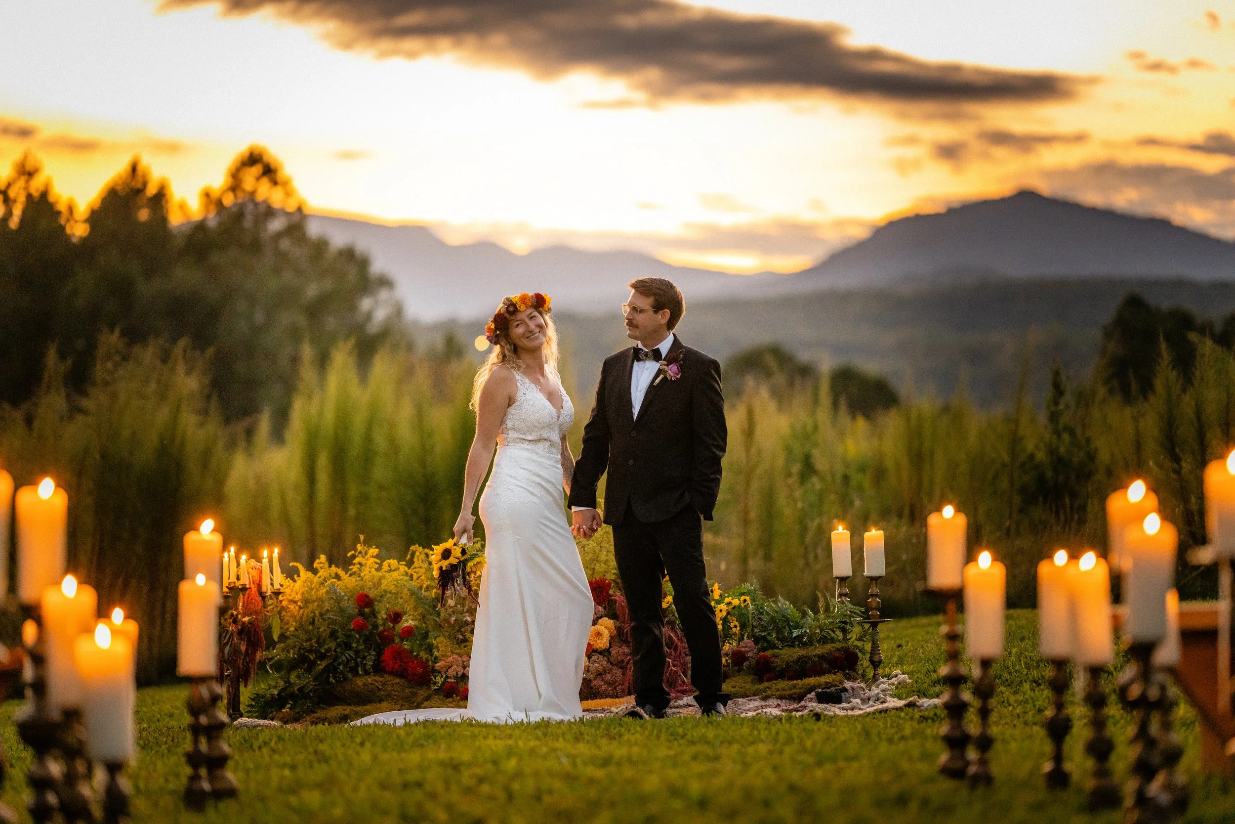 Asheville bride and groom stand with blue ridge mountains behind them.