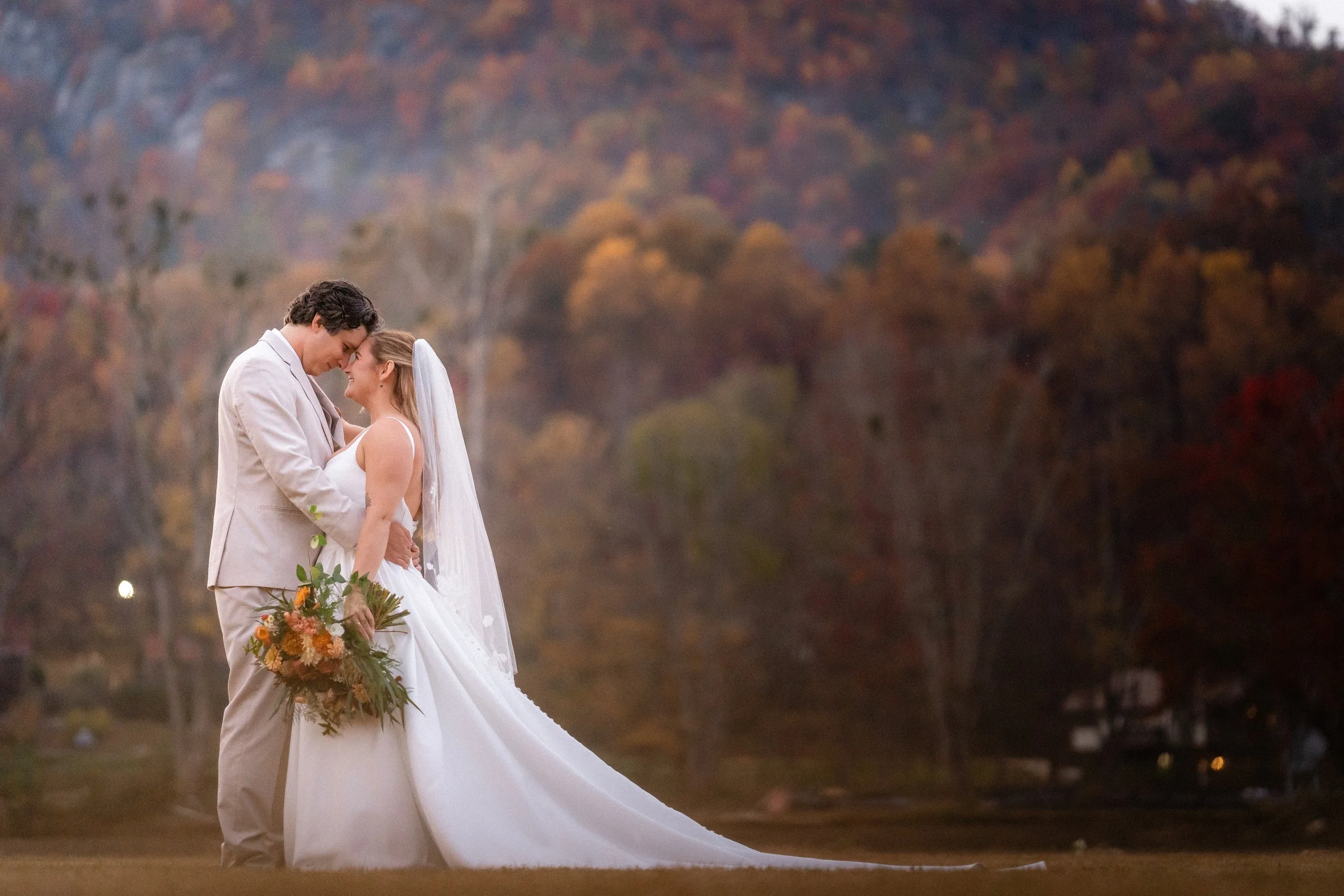 Newlyweds embracing at their Asheville wedding after Hurricane Helene.