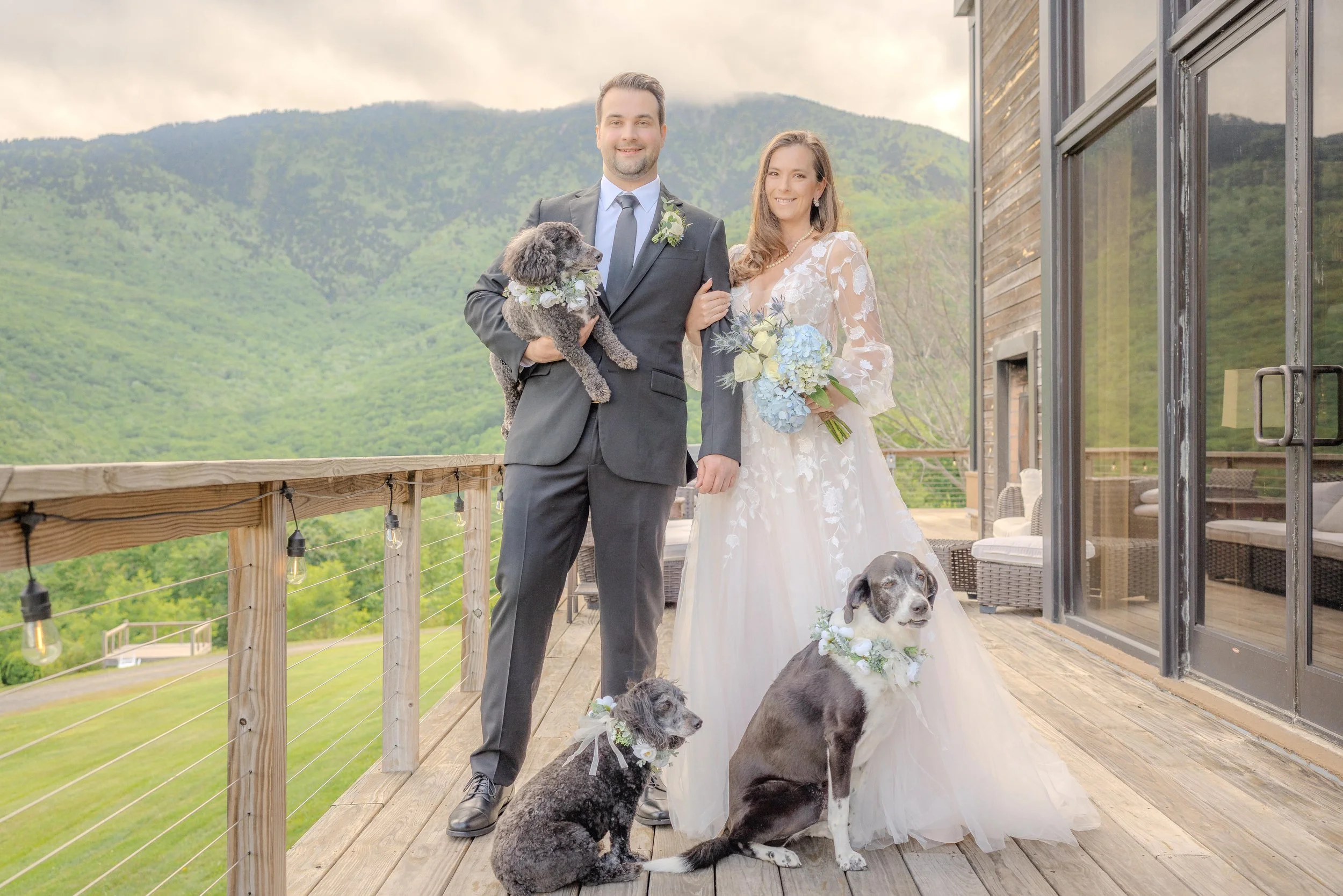 Bride and groom holding their dogs on wedding day, pet-friendly wedding photography.