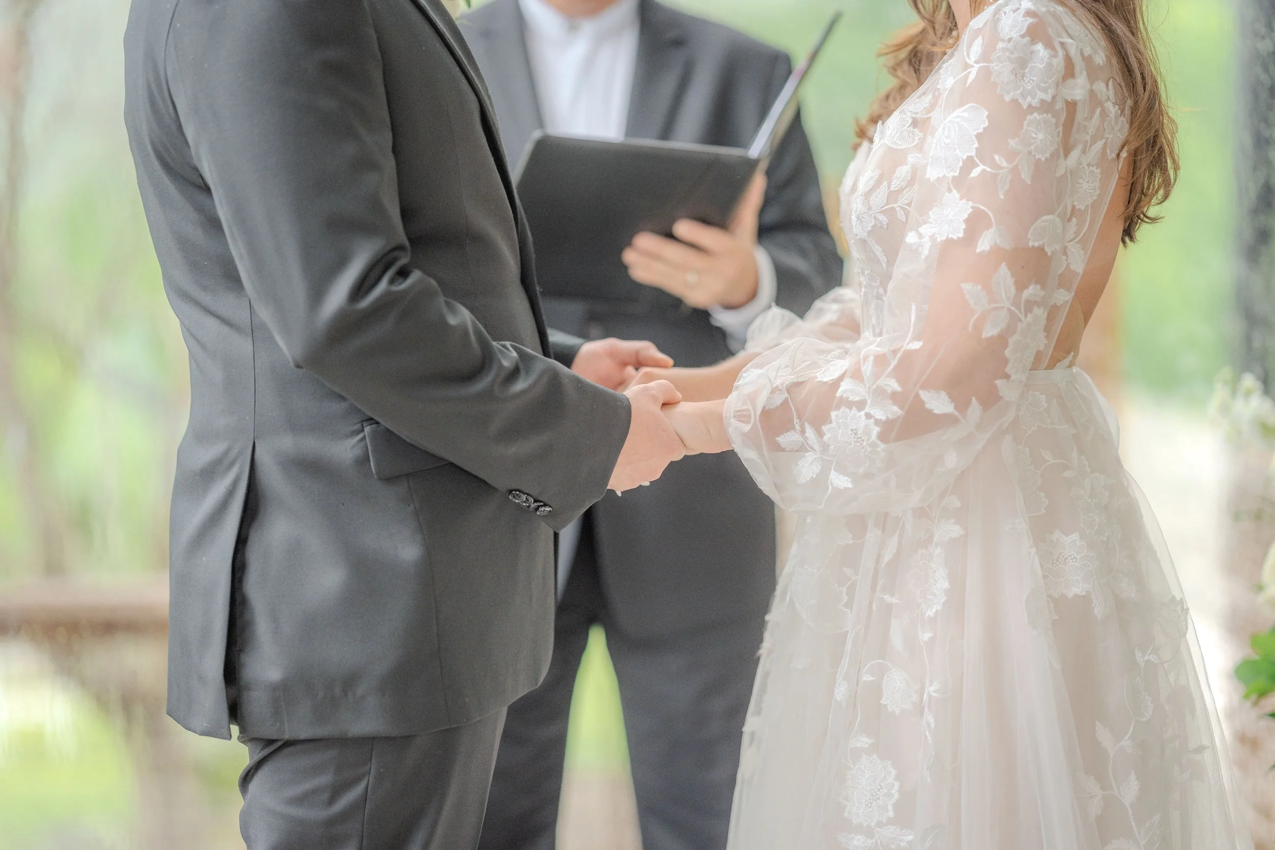 Bride and groom holding hands during a micro wedding in Western North Carolina.