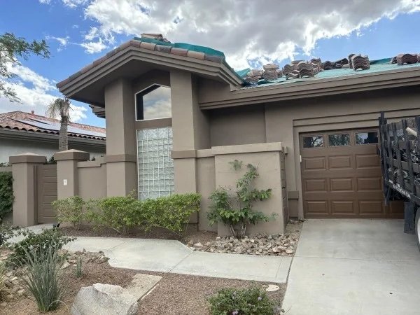 Residential tile roof undergoing replacement above attached garage