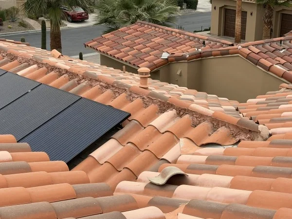 Clay tile roof with solar panels and repaired roof valley.