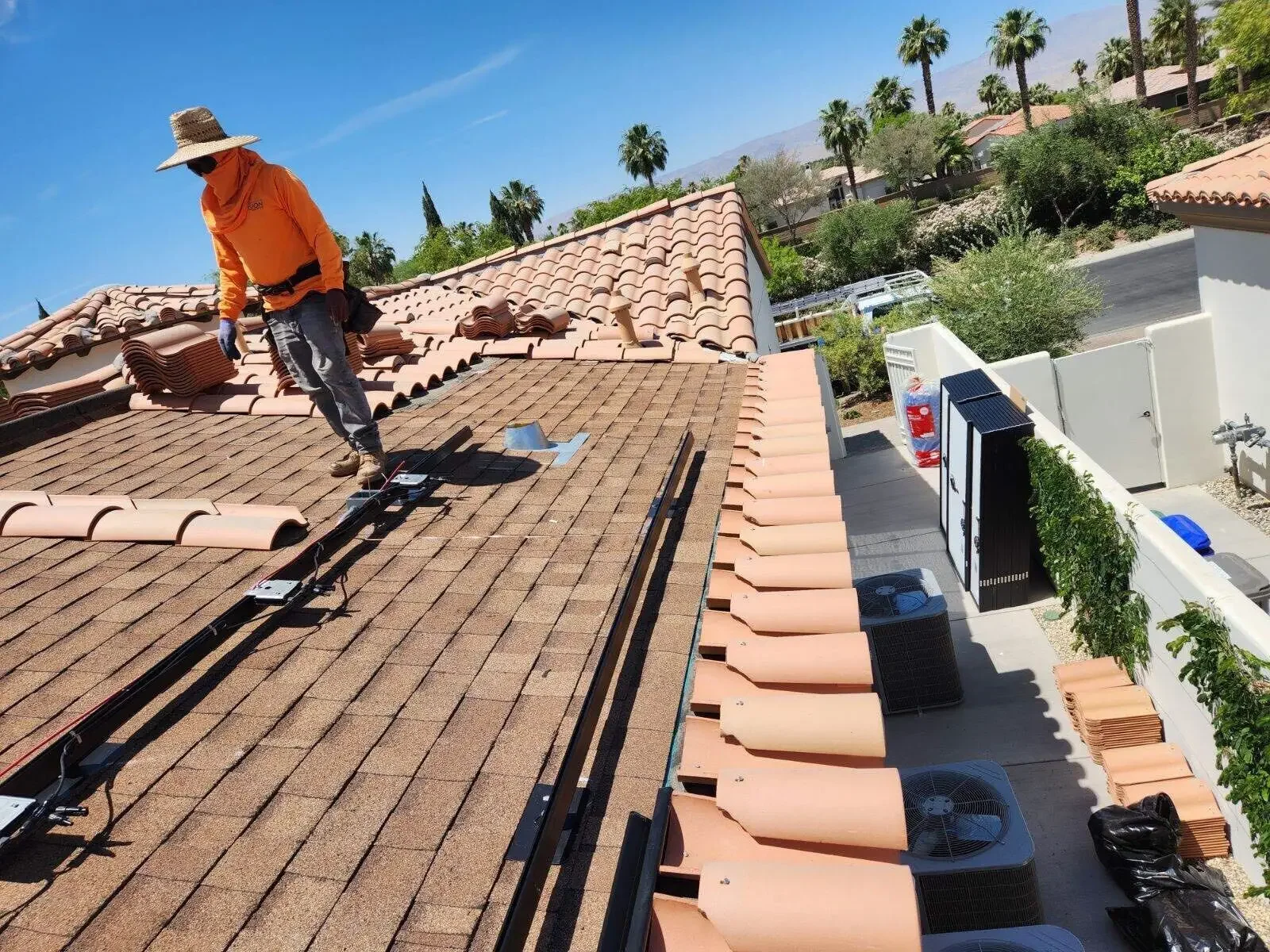 Roofer working on a residential tile roof in Palm Desert