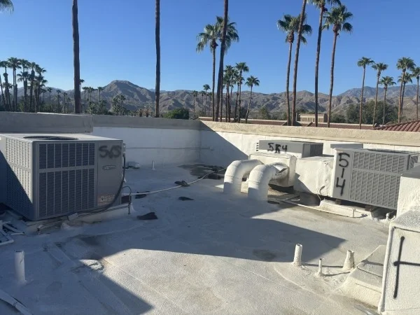 Residential flat roof with HVAC units and drainage penetrations
