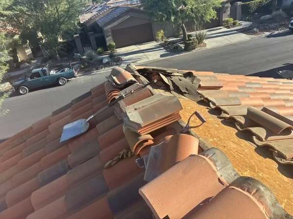 Roofer inspecting solar panels during residential roof replacement project.