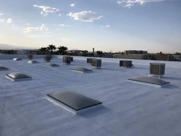 Completed reflective roof coating on commercial flat roofing system.