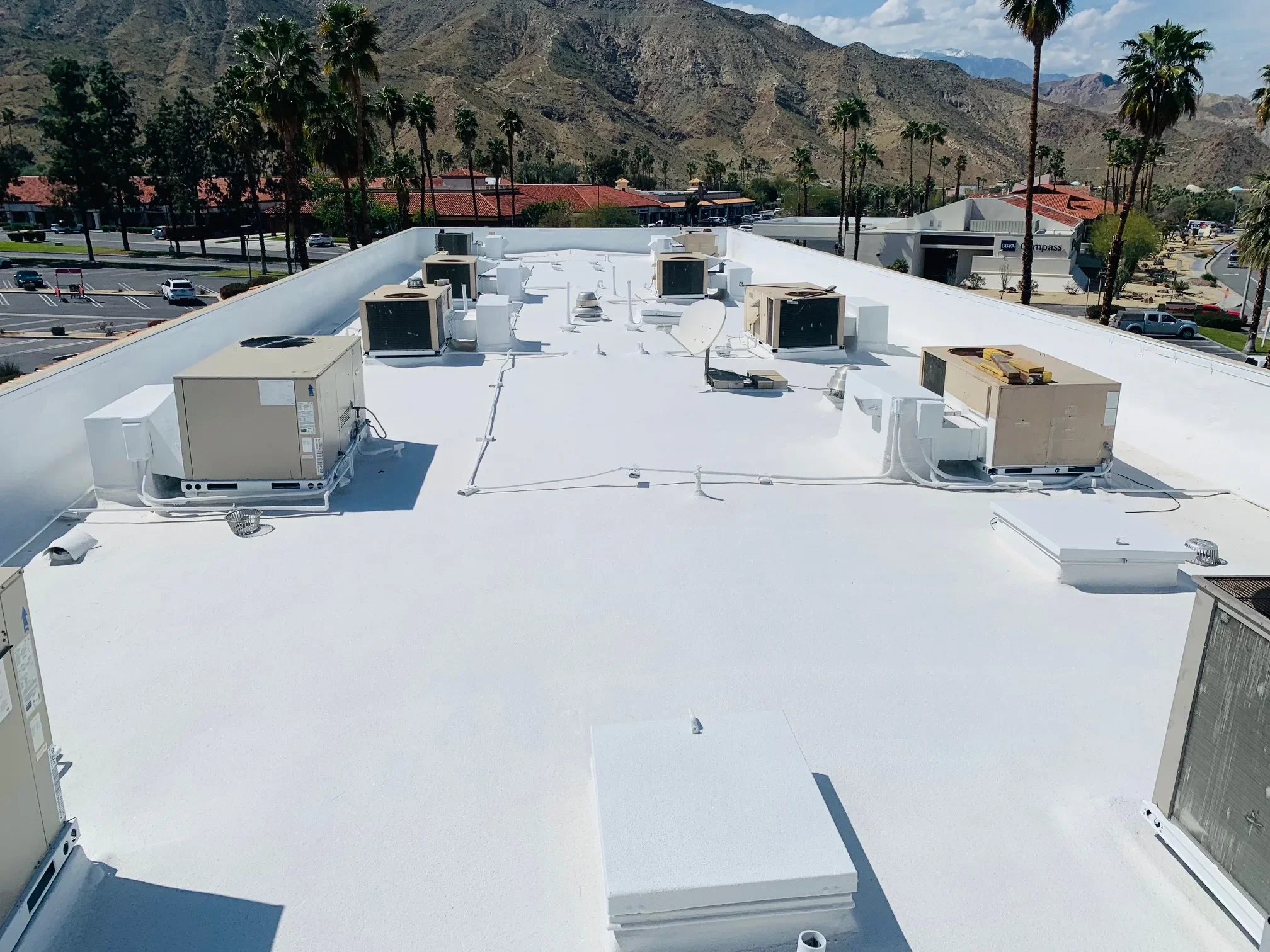 Commercial spray foam roof with rooftop HVAC units