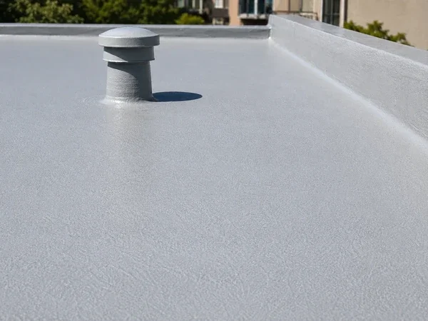 Spray foam roof with reflective silicone coating on a flat roof