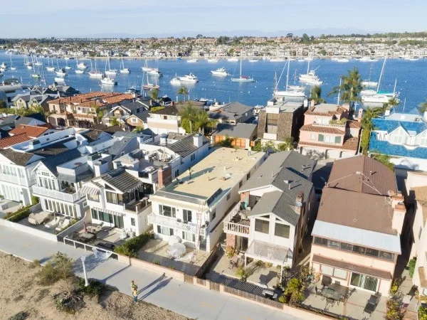 Coastal neighborhood showcasing completed residential flat roofing project.