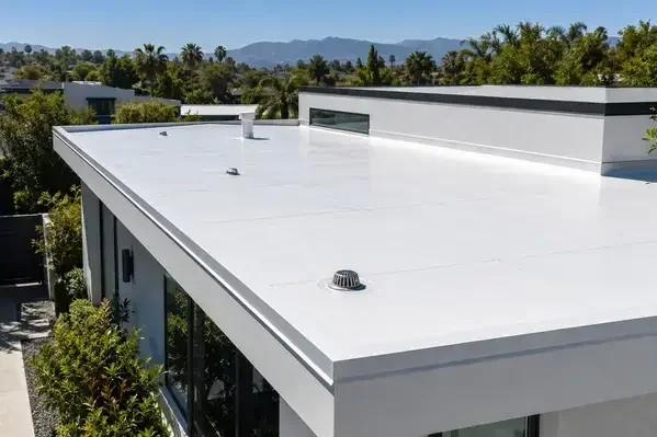 White reflective cool-roof membrane on a low-slope modern home