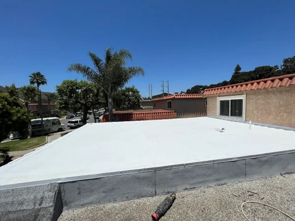 Completed white flat roof on residential building