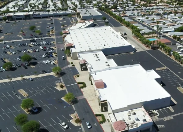 Aerial view of completed white commercial shopping center roof