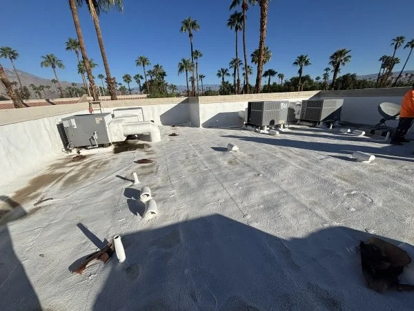 Weathered flat roof with multiple rooftop HVAC units