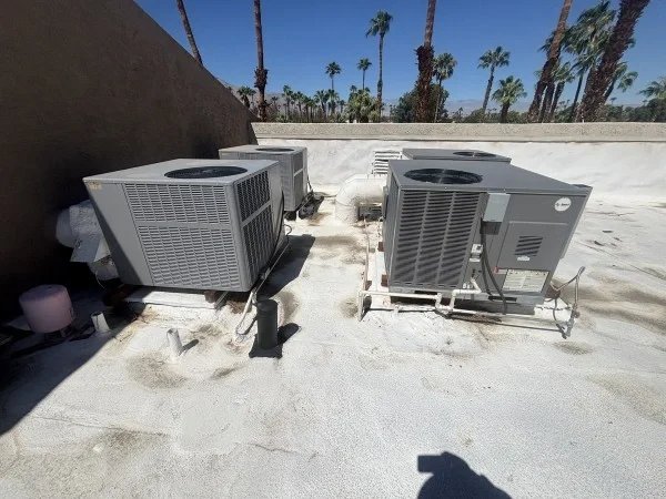 Rooftop HVAC units installed on coated flat roofing