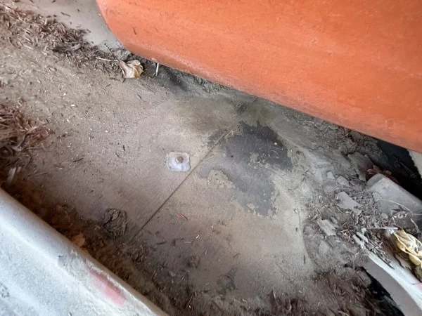 Roof underlayment inspection beneath removed concrete roof tiles.