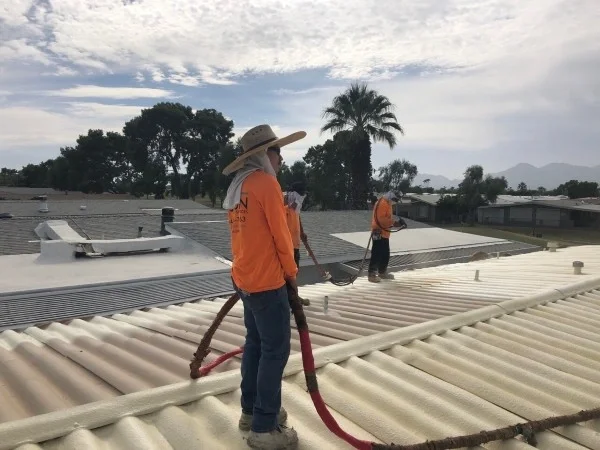 Concrete roof tiles organized across roof decking before installation.