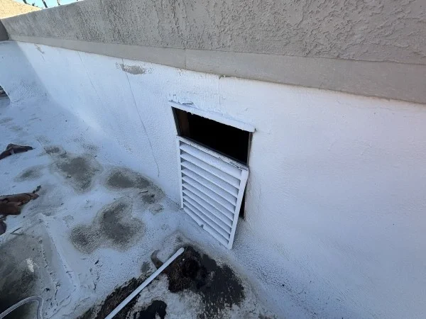 Water damage visible around vent on residential flat roof