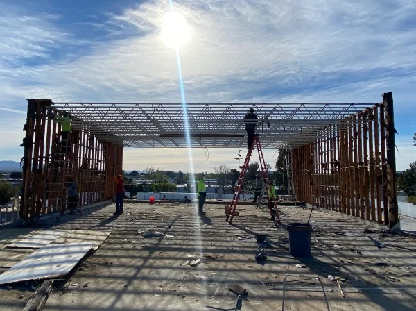 Commercial building steel framing under construction before roofing installation.