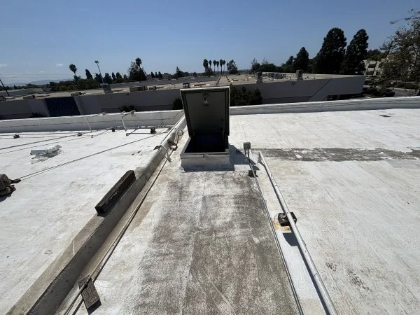 Commercial flat roof with access hatch and coating