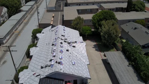 Aerial view of roof underlayment installed before shingle installation.
