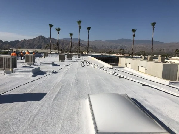 Restored commercial flat roof with HVAC units and skylights