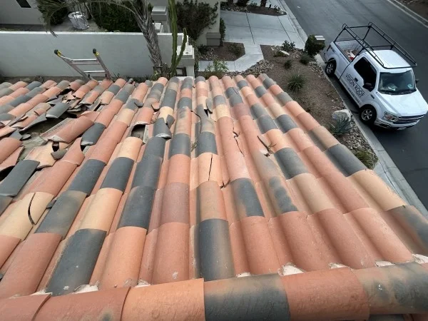Cracked clay roof tiles requiring professional roof repair and replacement.