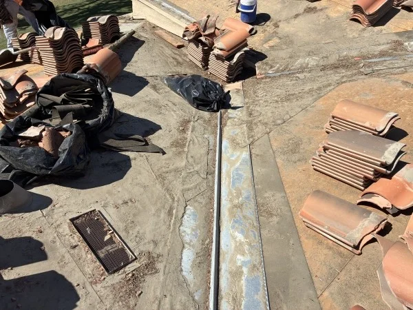 Roof valley flashing exposed during clay tile replacement