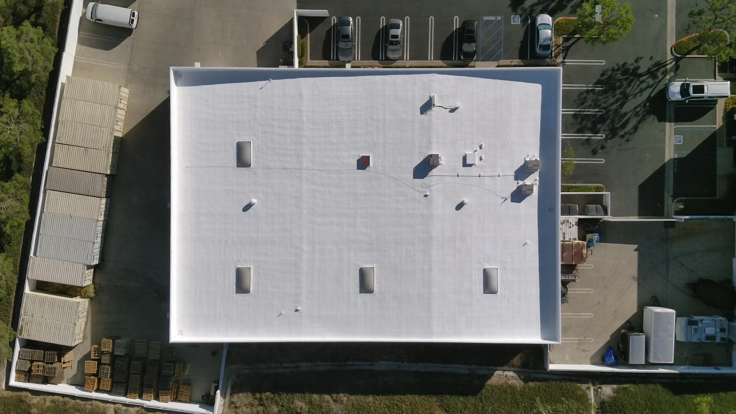 Aerial view of a white commercial flat roof