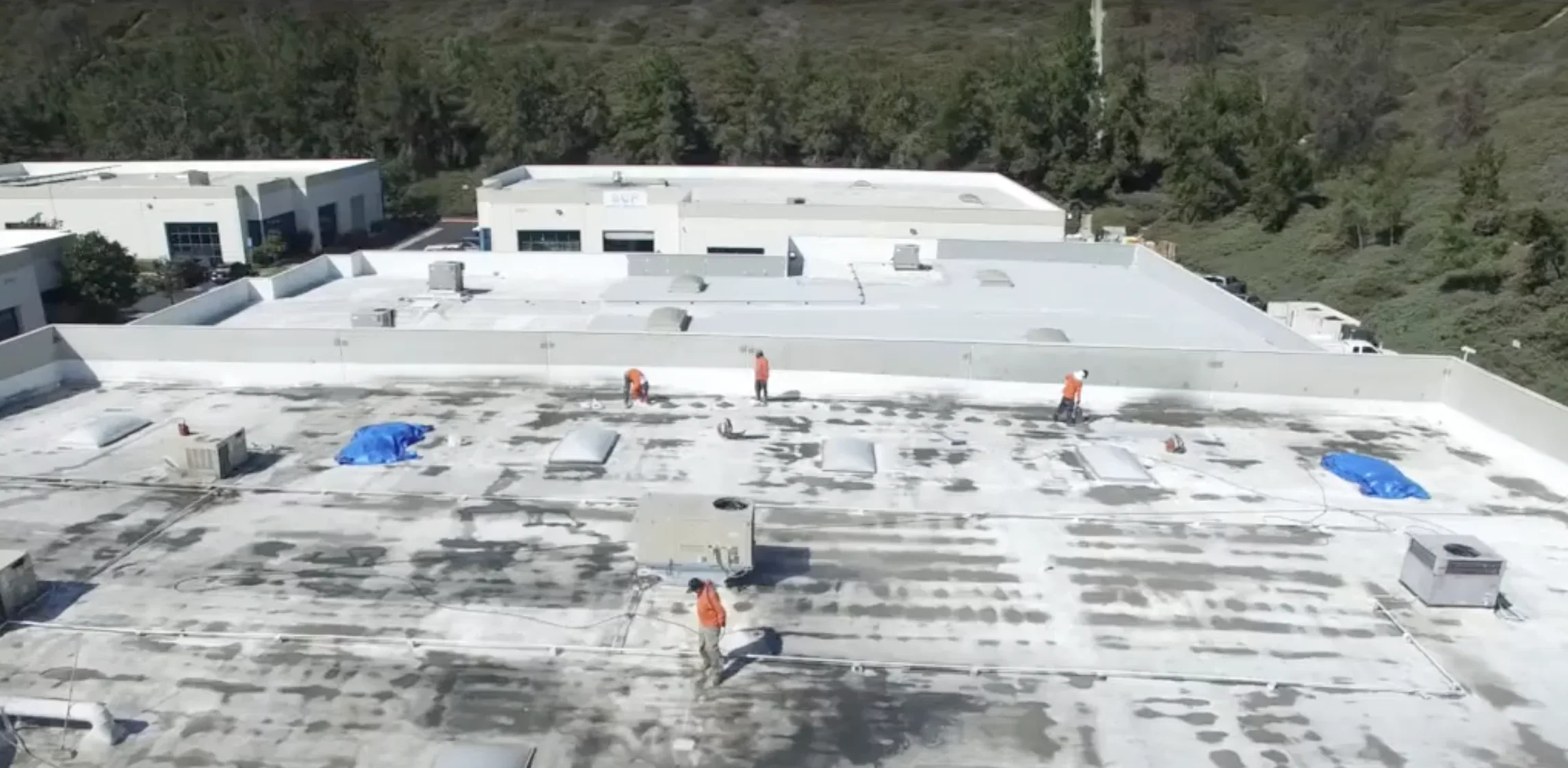 Commercial flat roof installation by roofing crew