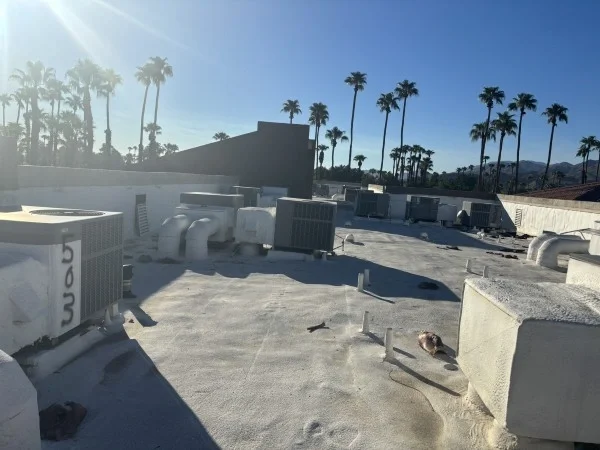 Aging commercial flat roof with multiple rooftop HVAC units