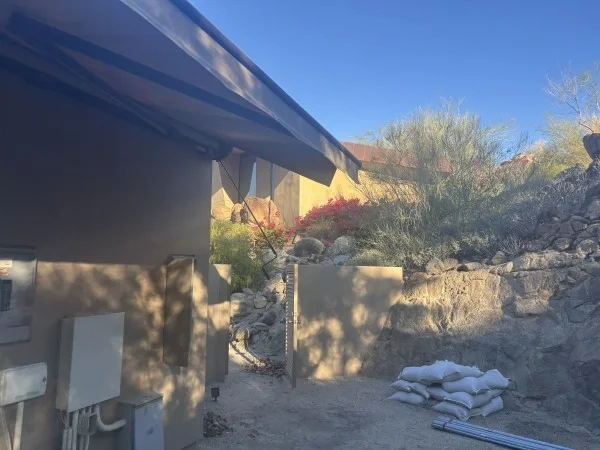 Side yard prepared for residential roofing project and access.