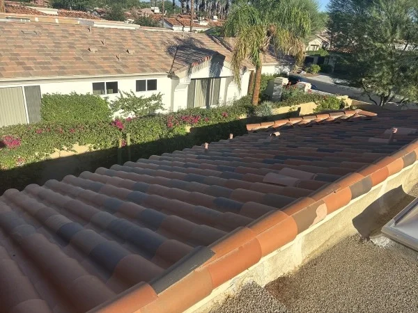 Completed clay tile roof overlooking landscaped residential neighborhood.