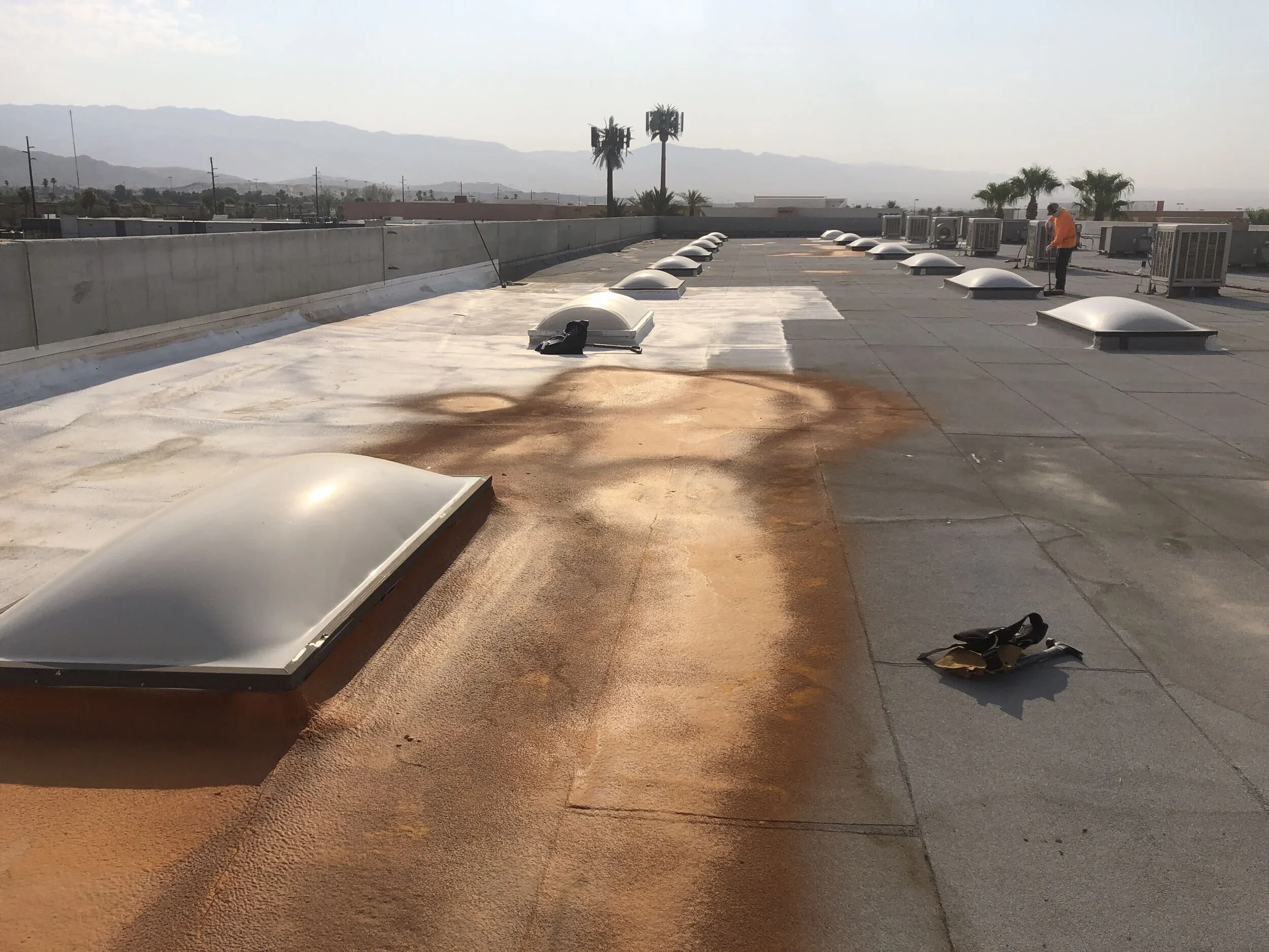 Commercial flat roof undergoing coating and restoration