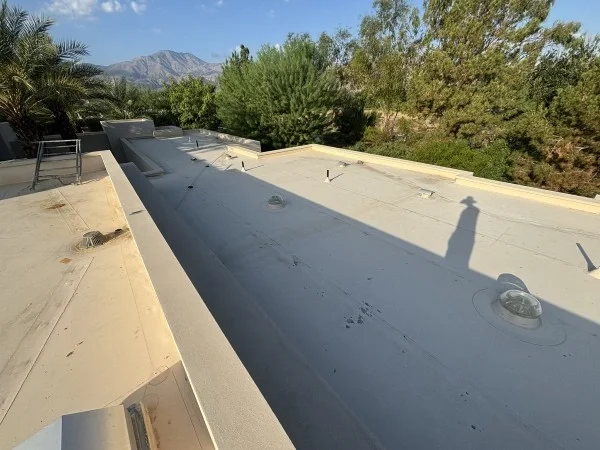 Flat residential roof prepared for reflective roof coating installation.