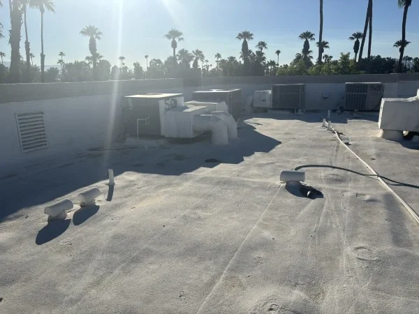 Existing commercial flat roof before restoration and recoating project.