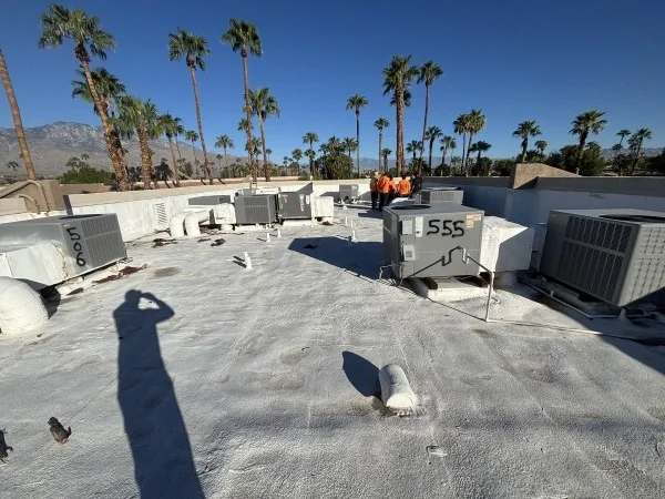 Commercial rooftop coated with reflective roofing around HVAC equipment.
