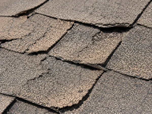 Sun and UV roof damage: curling, cracked, faded shingles