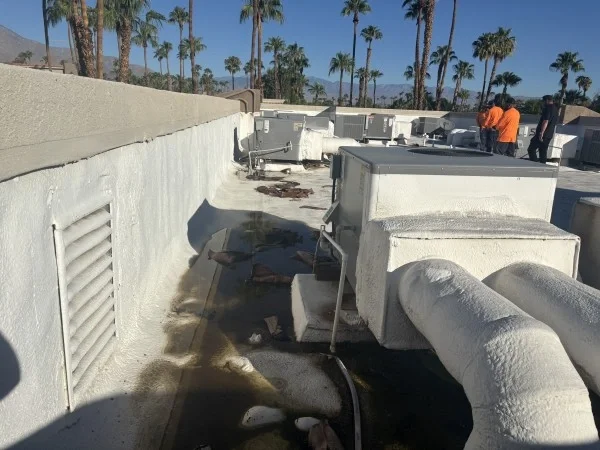 Ponding water surrounding HVAC equipment on commercial flat roof