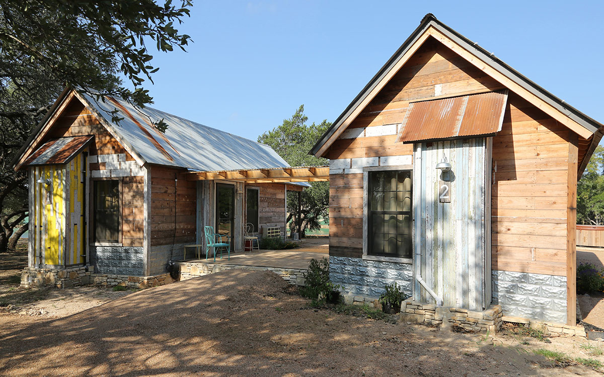 Exterior view of two cabins with covered dog run