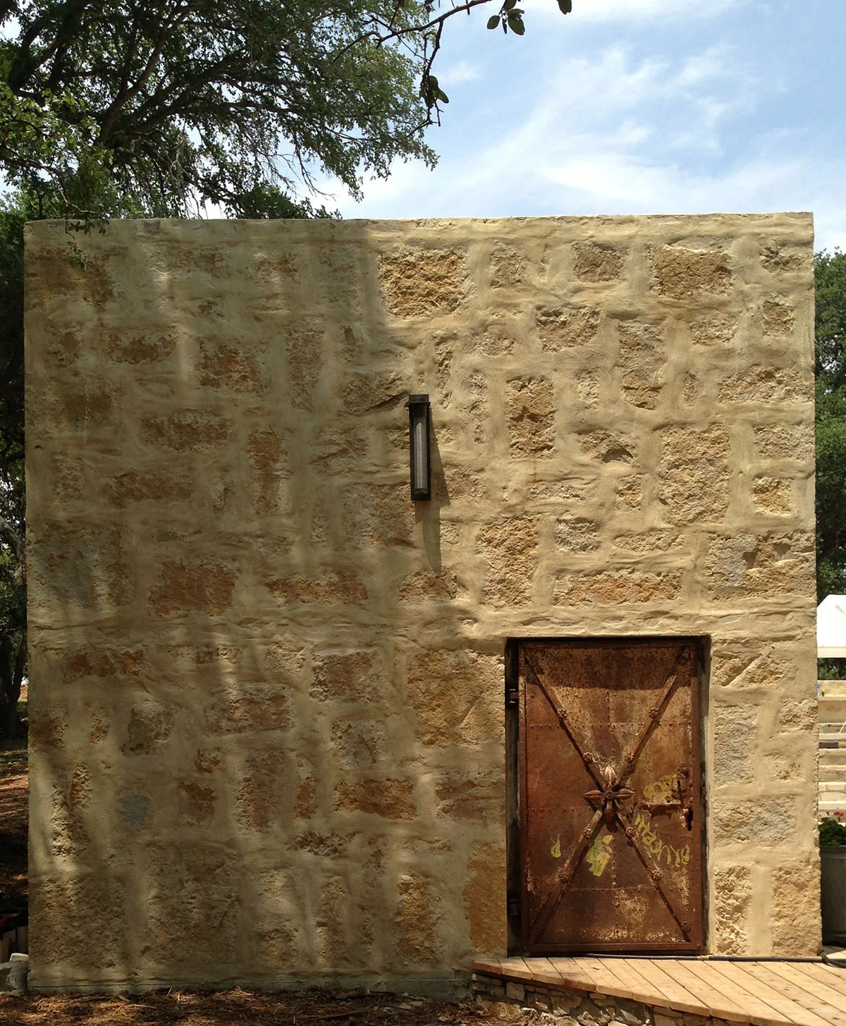 Pool equipment room with reclaimed metal door - DH