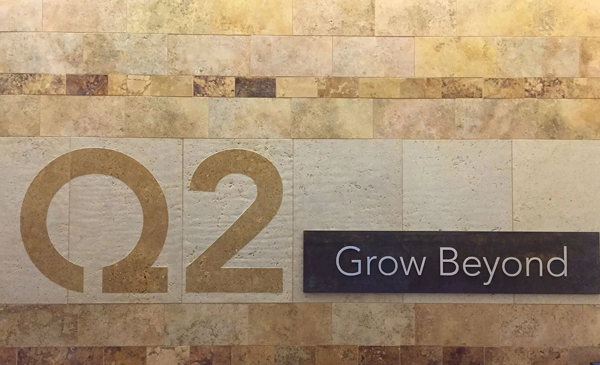 Main lobby stone tile wall with integrated logo
