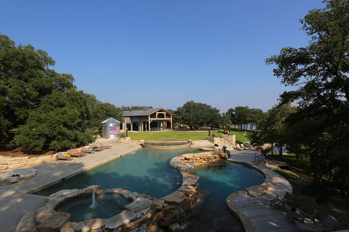 View of terraced pool and Activity Lawn and Party Barn beyond - PB
